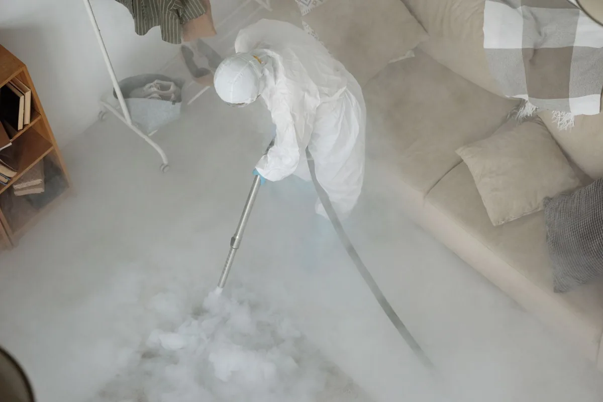 Biohazard cleanup technician in protective equipment, Plains, TX